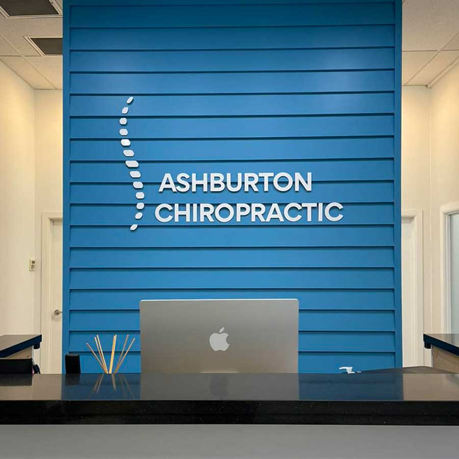 Ashburton Chiropractic Clinic reception with logo on wall
