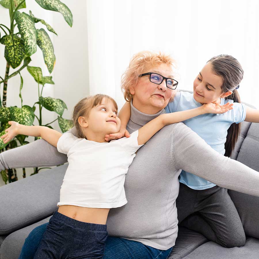 Older lady playing with grandchildren after chiropractic treatment